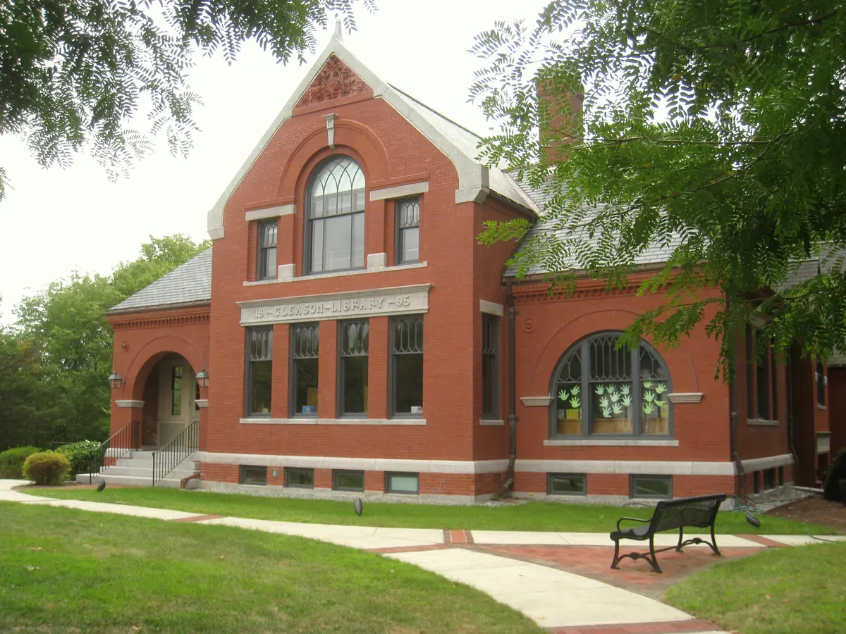 Gleason Public Library in Carlisle, MA, a red brick building with granite trim and arched windows