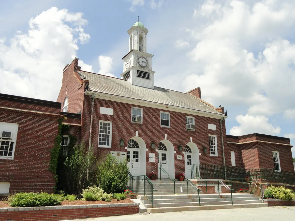 Tewksbury Town Hall, a red brick building with a white clock tower, on Main Street