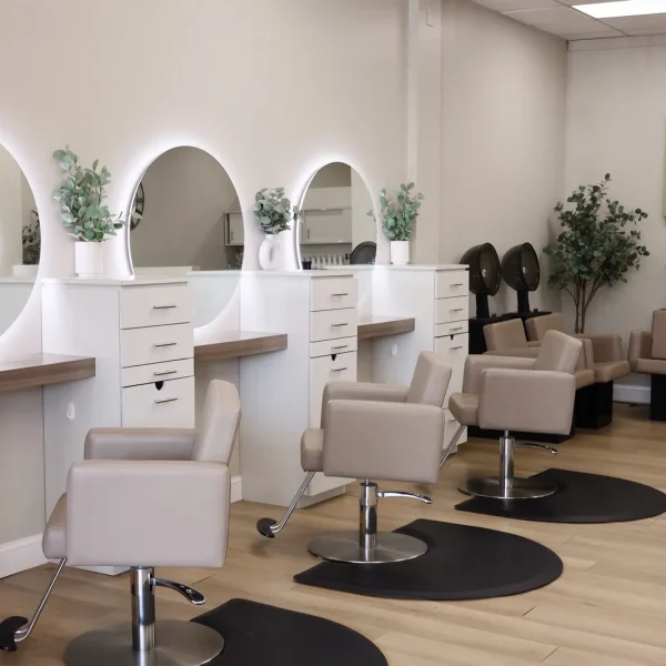 Salon chairs and round lighted mirrors inside Bella Mia Hair Salon in Billerica, MA