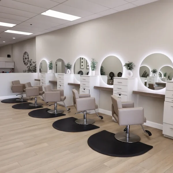 Styling stations with round mirrors inside Bella Mia Hair Salon in Billerica, MA