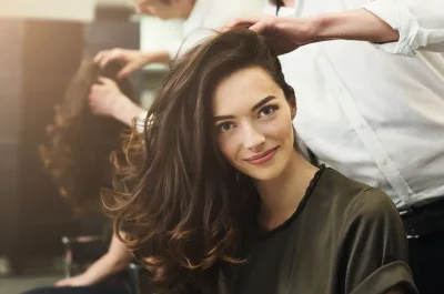 Woman with a voluminous curled blowout at a Billerica MA salon