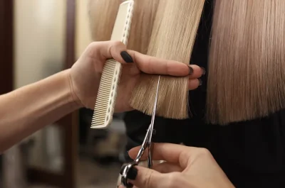 Stylist precision-cutting a blonde bob at a Billerica hair salon
